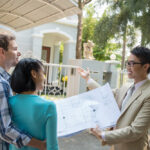 A couple talking to a realtor about buying a home