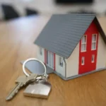 Illustration photo for MORTGAGE. A small house and a set of keys on a key chain
